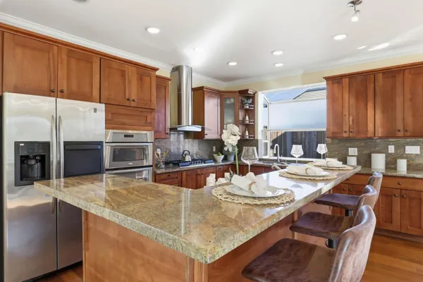 a kitchen with a sink refrigerator and cabinets