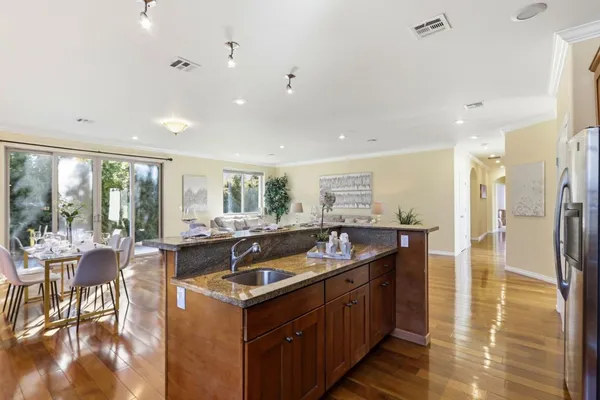 a kitchen with stainless steel appliances granite countertop a sink and a stove