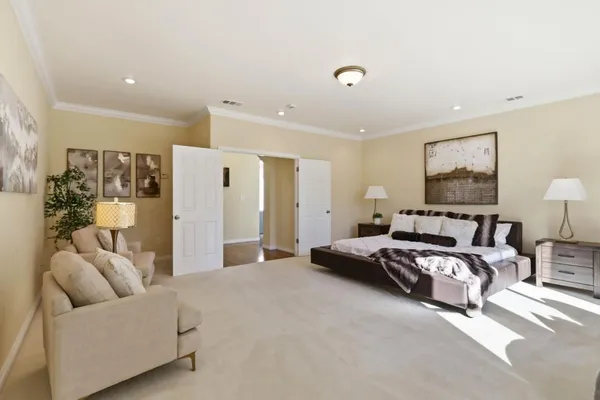 a spacious bedroom with a bed and furniture