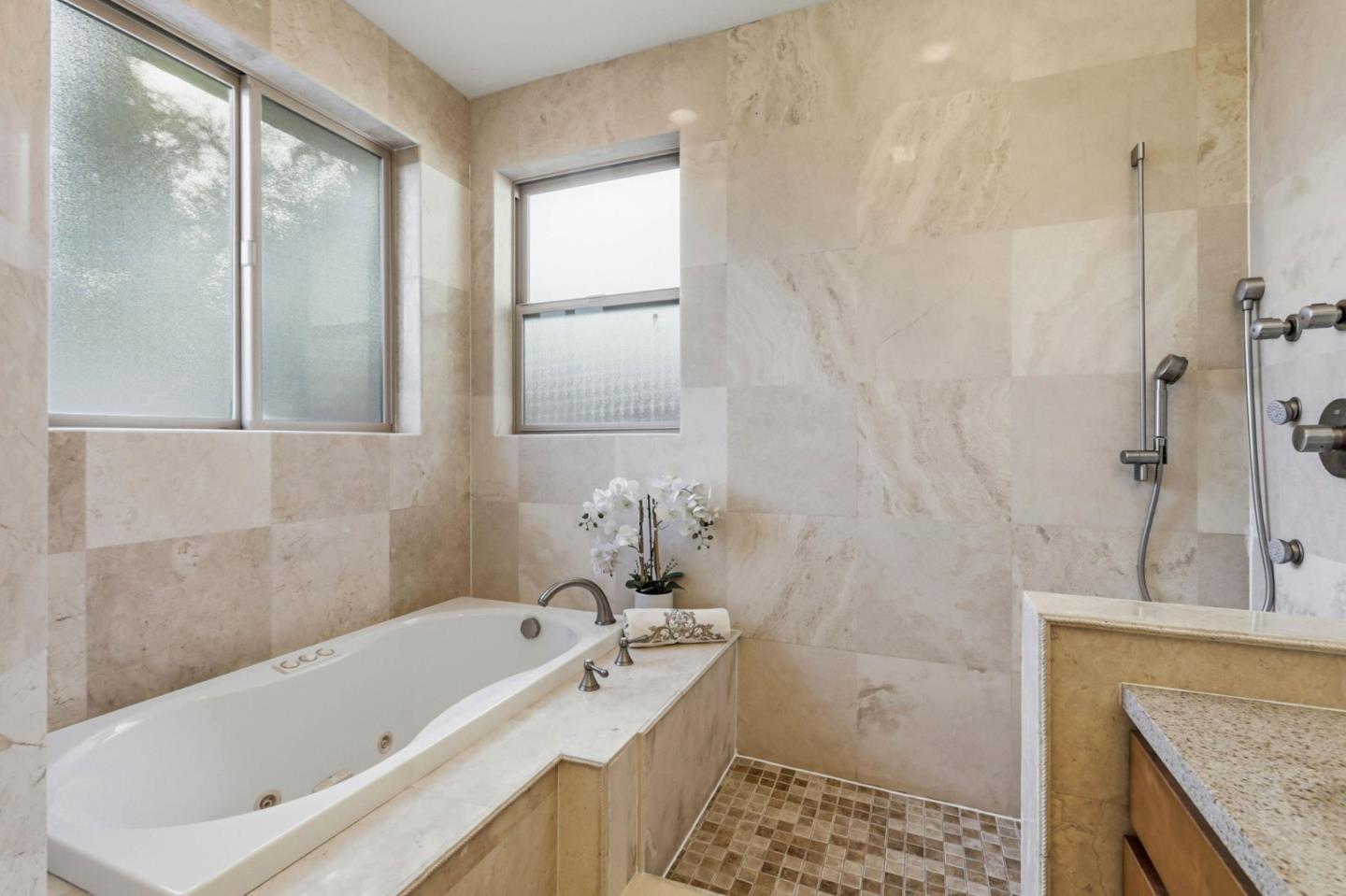 1352 South Stelling Road Cupertino, CA 95014 - Photo 30 of 49 a bathroom with a granite countertop tub sink and mirror