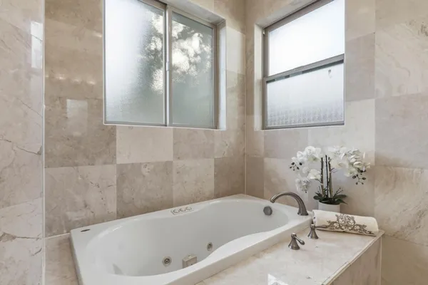 a bathroom with a tub and a shower