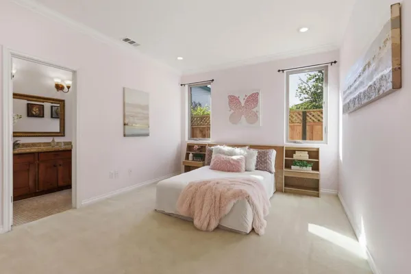 a bedroom with a bed and a view of kitchen