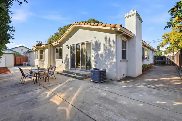 a view of a house with backyard and sitting area