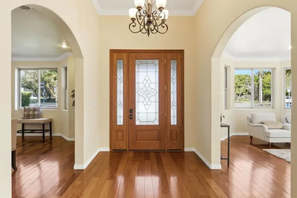 a view of a livingroom with furniture hardwood floor and hallway