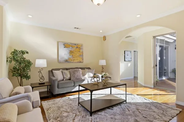 a living room with furniture and a potted plant