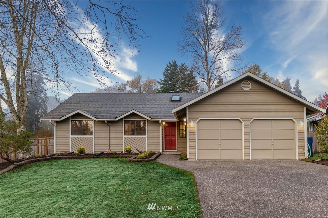 a view of a house with a yard and garage