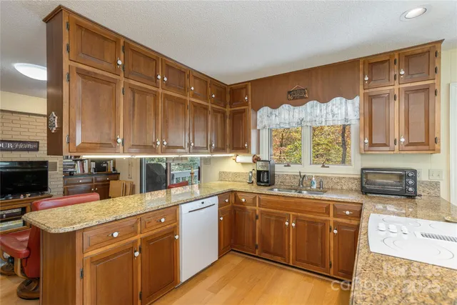 a kitchen with a sink stove and cabinets