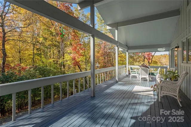 a view of a porch with chairs and wooden floor