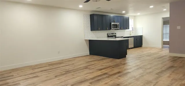 a view of kitchen with microwave and cabinets