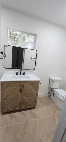 a bathroom with a shower and a tiled wall