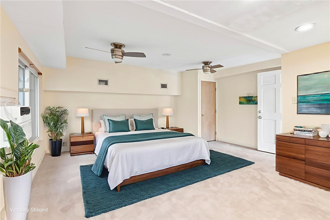 1225 Jonnell Street Corpus Christi, TX 78418 - Photo 12 of 39 a spacious bedroom with a bed table closet and a potted plant