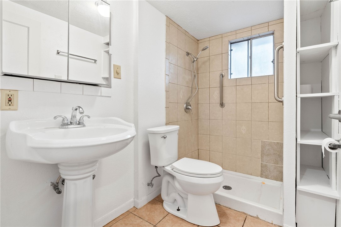1225 Jonnell Street Corpus Christi, TX 78418 - Photo 17 of 39 a bathroom with a sink toilet and shower