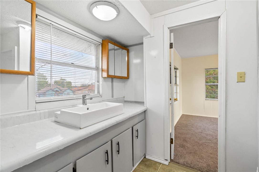 1225 Jonnell Street Corpus Christi, TX 78418 - Photo 23 of 39 a bathroom with a sink a vanity and a mirror