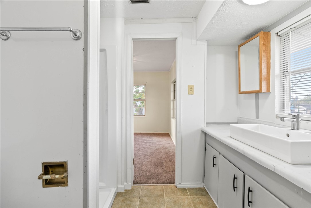 1225 Jonnell Street Corpus Christi, TX 78418 - Photo 24 of 39 a bathroom with a sink and a mirror