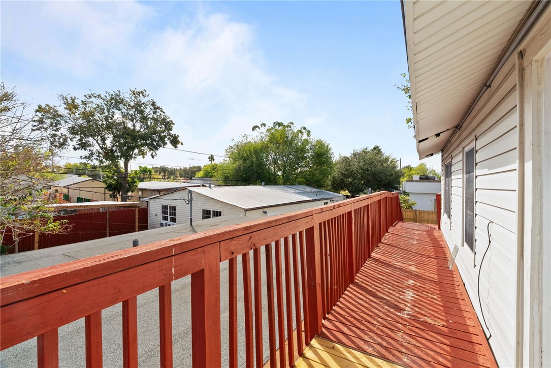 1225 Jonnell Street Corpus Christi, TX 78418 - Photo 25 of 39 a balcony with wooden floor next to a yard