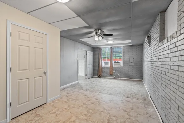 a view of a hallway with a chandelier fan