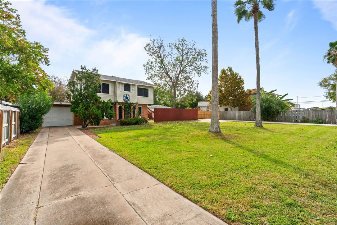 1225 Jonnell Street Corpus Christi, TX 78418 - Photo 3 of 39 a front view of a house with a yard and a tree