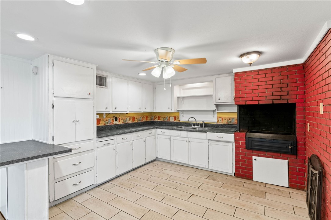 1225 Jonnell Street Corpus Christi, TX 78418 - Photo 9 of 39 a kitchen with granite countertop a stove a sink and a refrigerator