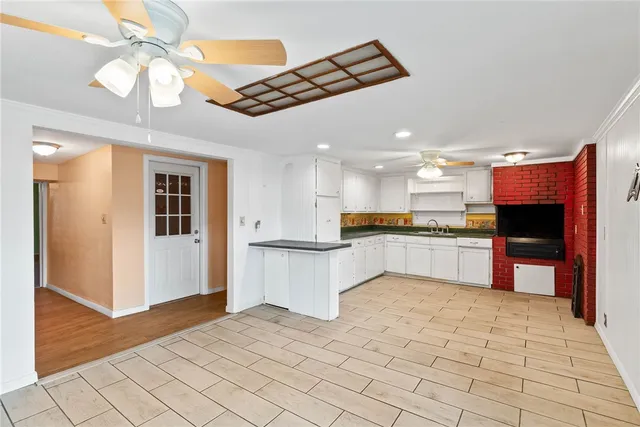 a large kitchen with cabinets and stainless steel appliances