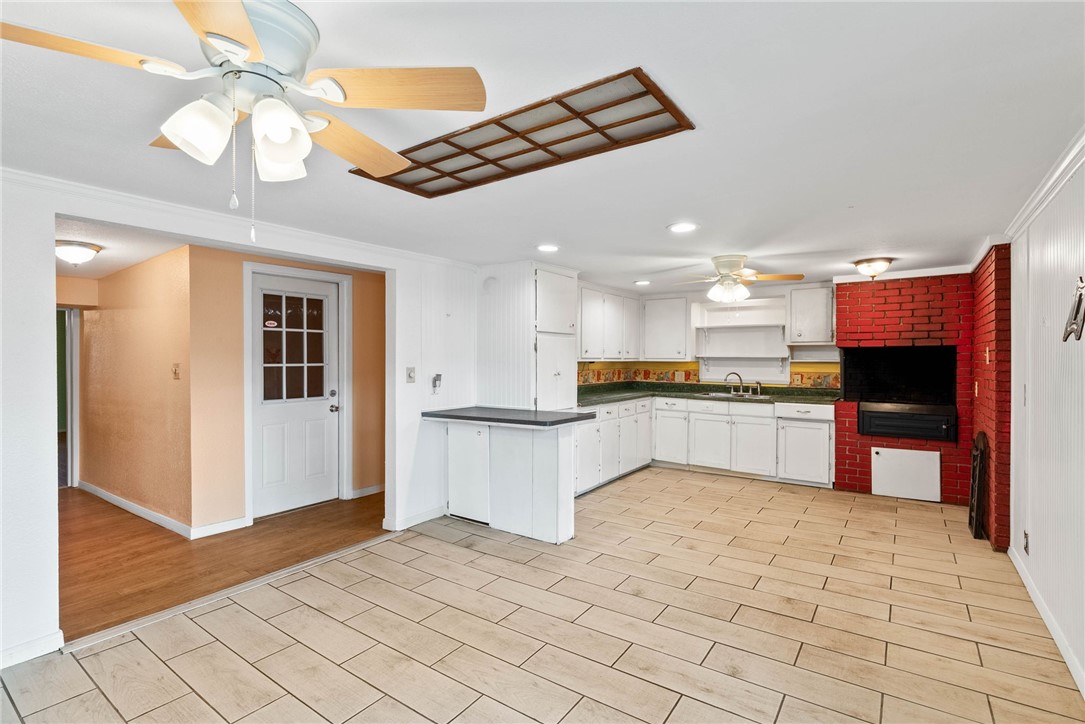 1225 Jonnell Street Corpus Christi, TX 78418 - Photo 10 of 39 a large kitchen with cabinets and stainless steel appliances