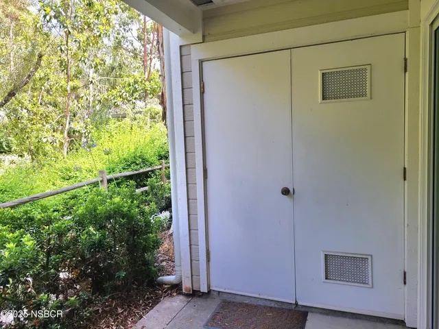 a view of a wooden fence and trees