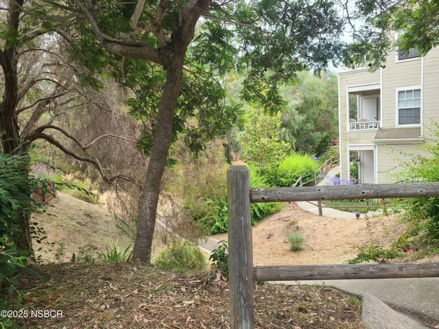 a view of a backyard with swimming pool