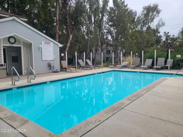 a view of a house with backyard and sitting area