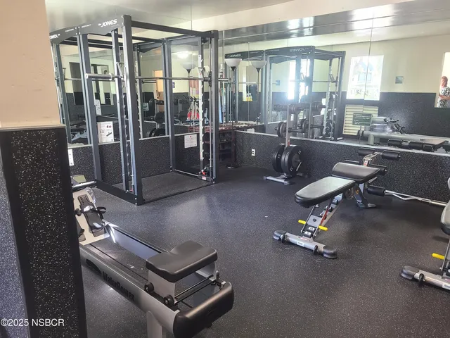 a view of a patio with chairs under an umbrella