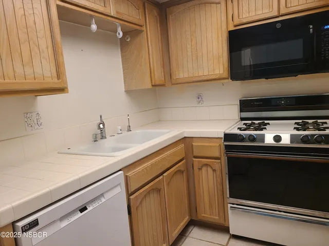a kitchen with stainless steel appliances a stove and a refrigerator