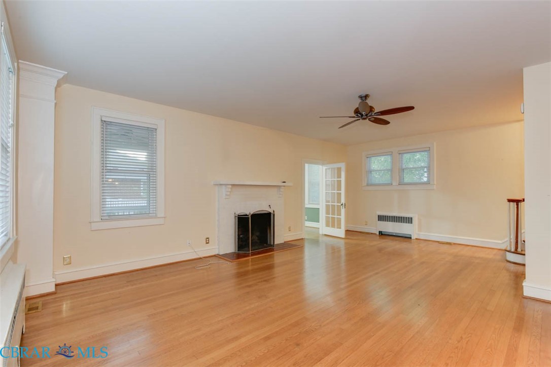 144 Meredith Street Hampton, VA 23669 - Photo 6 of 36 a view of an empty room with a fireplace and a window