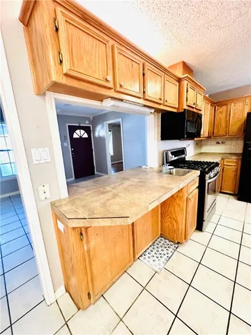 a kitchen with stainless steel appliances kitchen island granite countertop a sink and cabinets