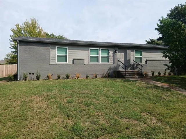 a front view of house with yard outdoor seating