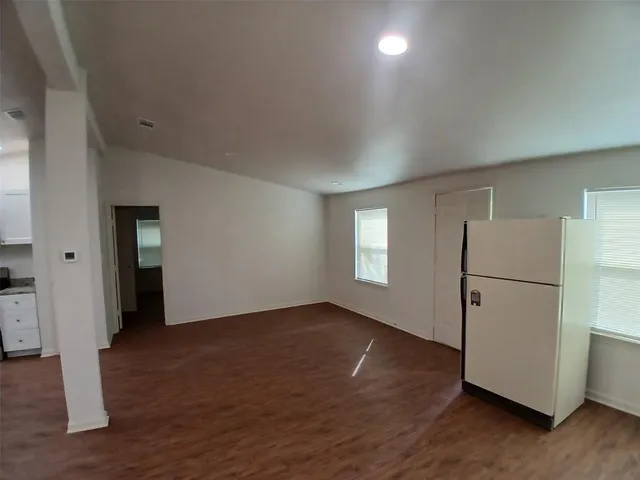 a view of a refrigerator in kitchen and wooden floor