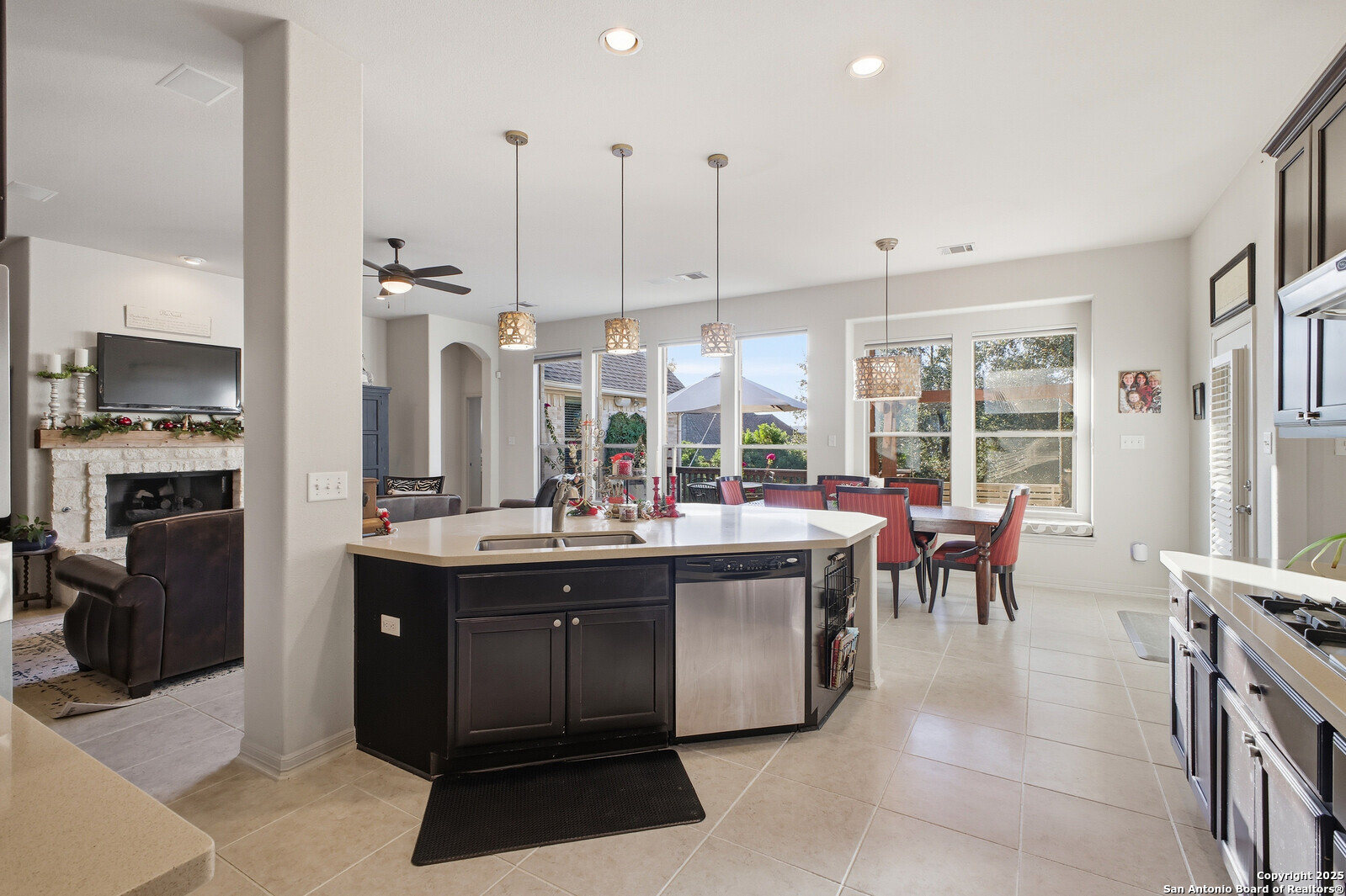 25523 River Ranch San Antonio, TX 78255 - Photo 21 of 45 a view of a kitchen with kitchen island granite countertop a large counter top stainless steel appliances a sink and living room view