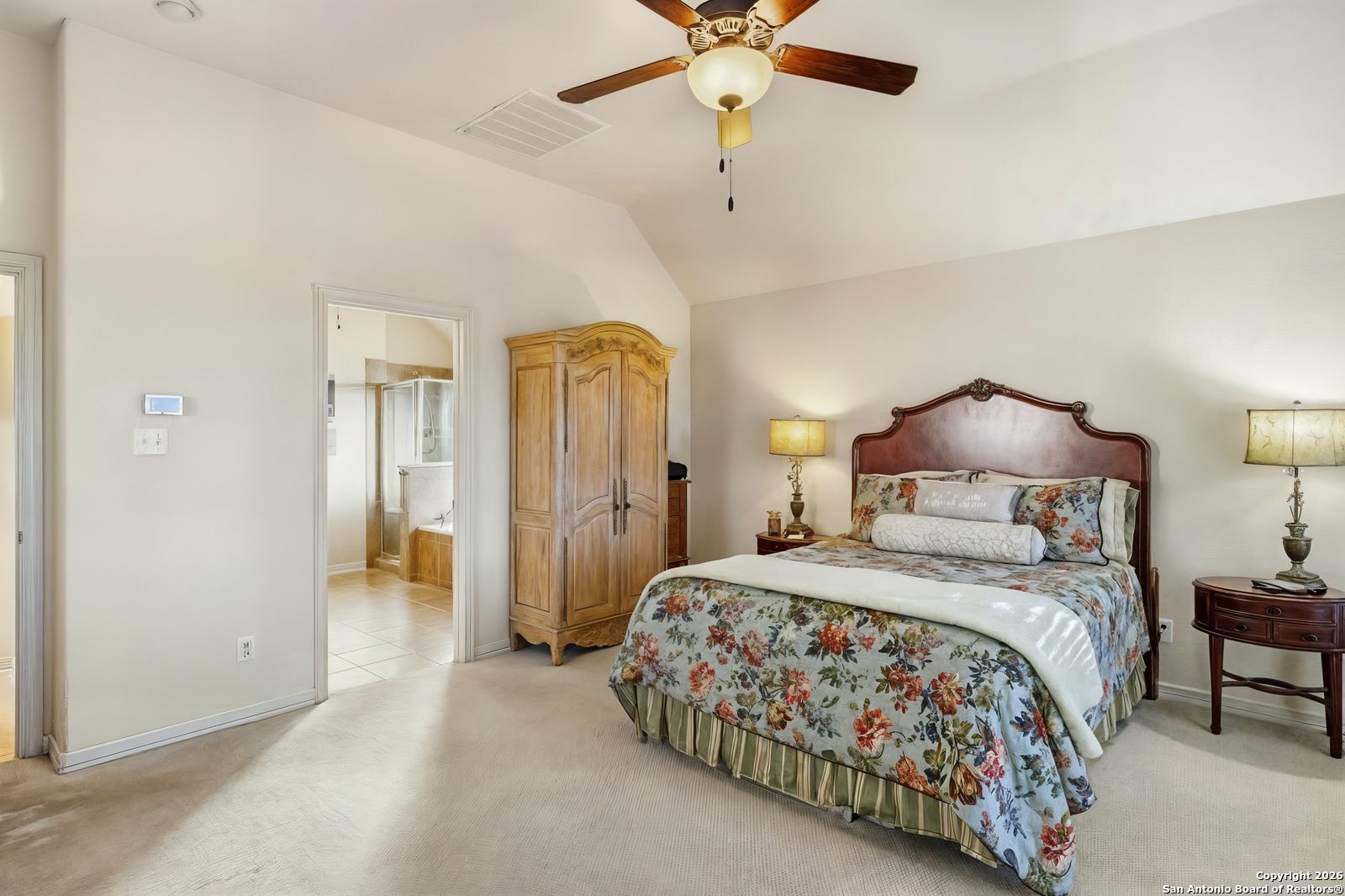 25523 River Ranch San Antonio, TX 78255 - Photo 24 of 41 a bedroom with a bed and a chandelier