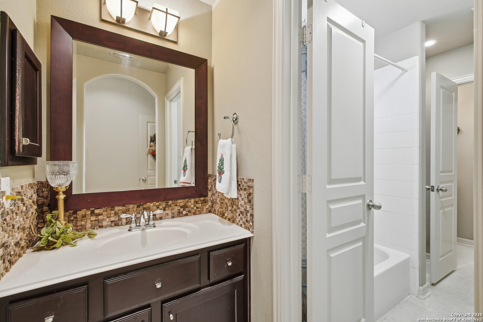 25523 River Ranch San Antonio, TX 78255 - Photo 26 of 41 a bathroom with a sink a mirror and a shower