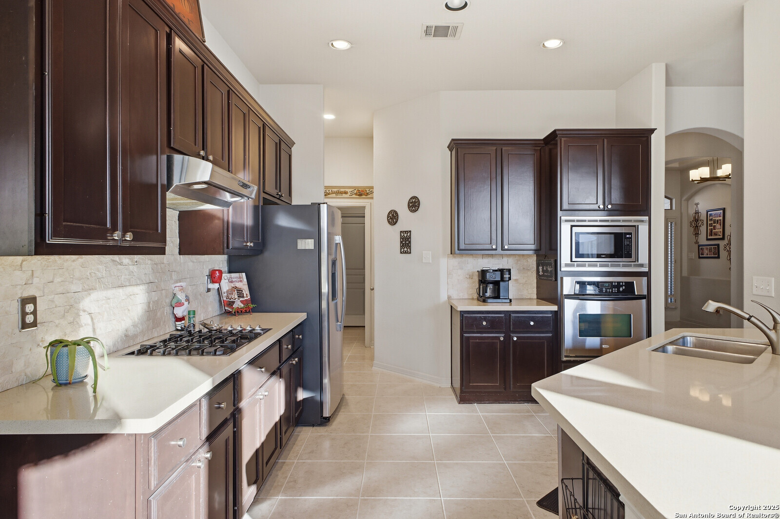 25523 River Ranch San Antonio, TX 78255 - Photo 3 of 41 a kitchen with stainless steel appliances kitchen island granite countertop a refrigerator stove and sink