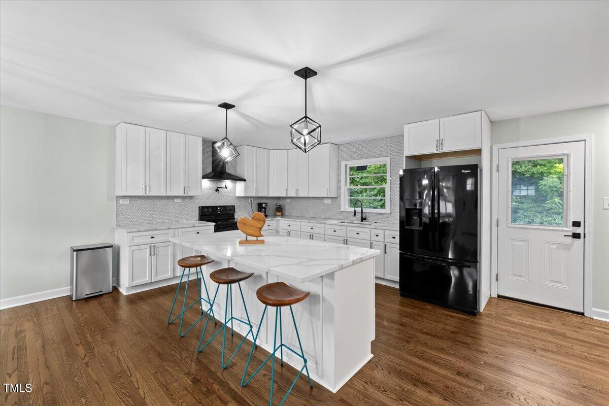 4312 James Road Raleigh, NC 27616 - Photo 13 of 44 a kitchen with kitchen island white cabinets and refrigerator