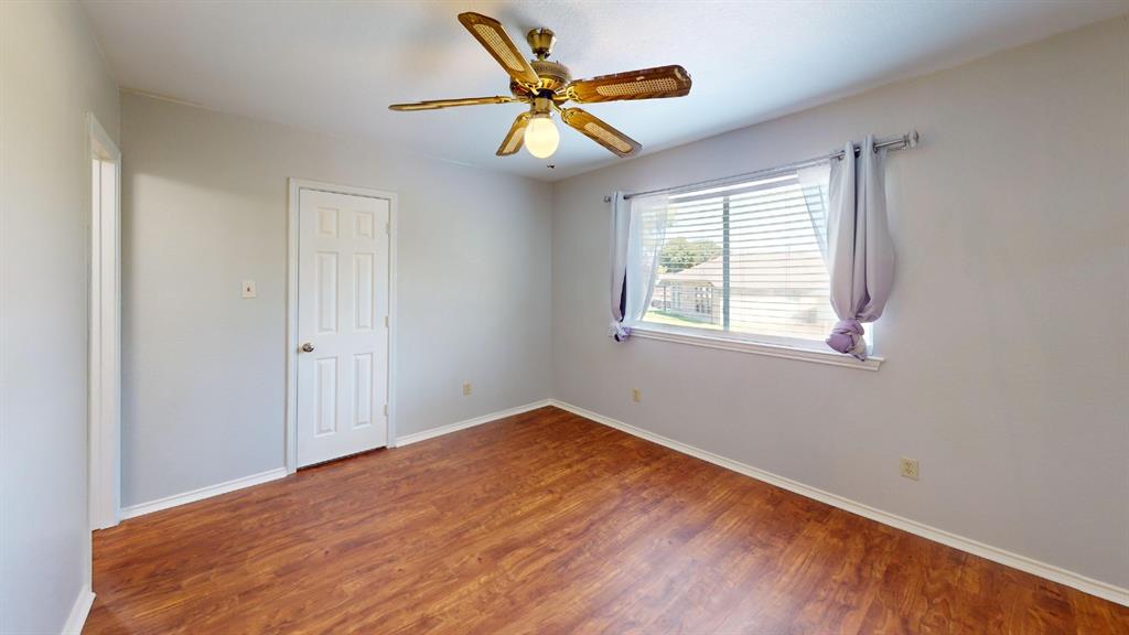 7913 Rice Drive Rowlett, TX 75088 - Photo 17 of 25 Room featuring wood-finish flooring, light gray walls, and white trim