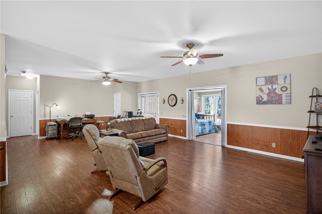 3400 Old Dobbins Bridge Road Fair Play, SC 29643 - Photo 12 of 50 This expansive living area features lustrous wood flooring and elegant paneling, offering a welcoming ambiance.