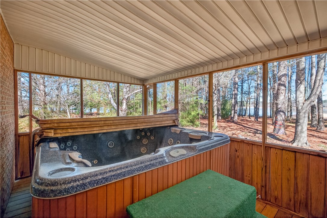 3400 Old Dobbins Bridge Road Fair Play, SC 29643 - Photo 21 of 50 Relax in the hot tub with a beautiful view of the surrounding trees and lake.