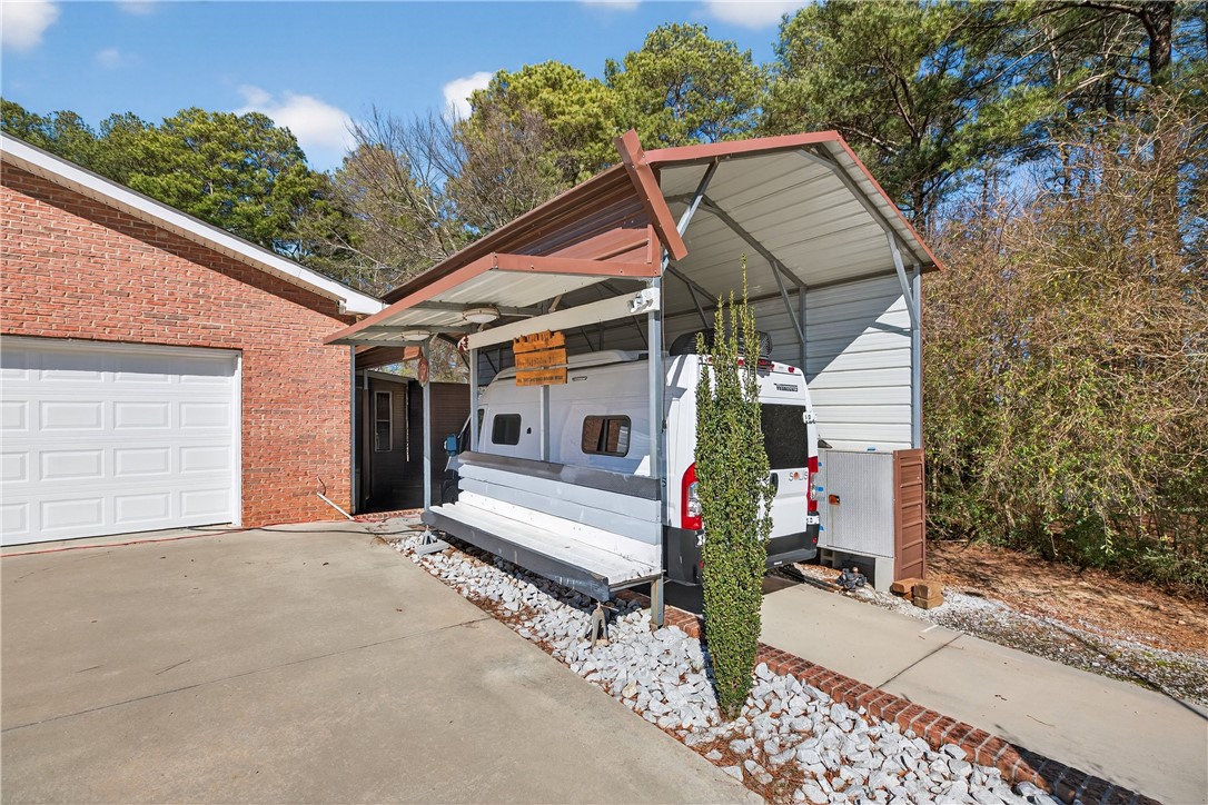 3400 Old Dobbins Bridge Road Fair Play, SC 29643 - Photo 28 of 50 This property features a functional carport and attached garage, offering ample space and convenience.