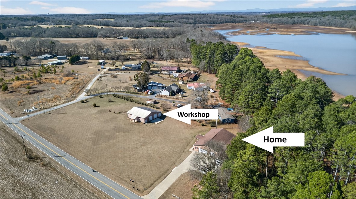 3400 Old Dobbins Bridge Road Fair Play, SC 29643 - Photo 43 of 50 An aerial perspective reveals a serene lakefront property with a spacious workshop and nearby residences.