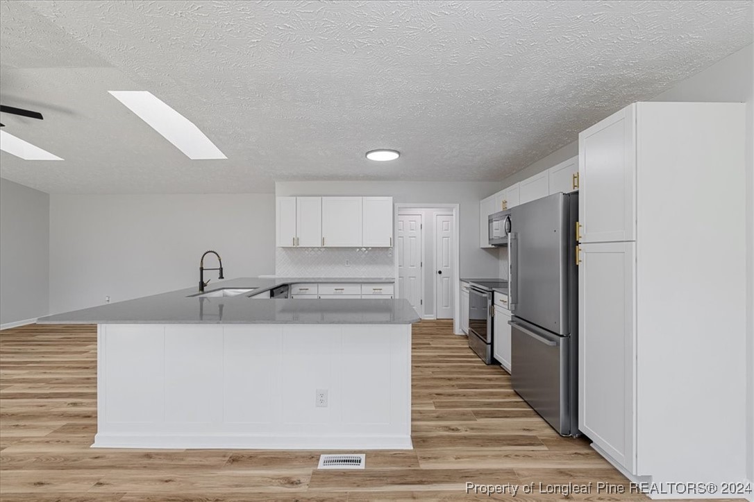 7847 Amesbury Road Fayetteville, NC 28311 - Photo 14 of 42 a kitchen with a refrigerator and a sink