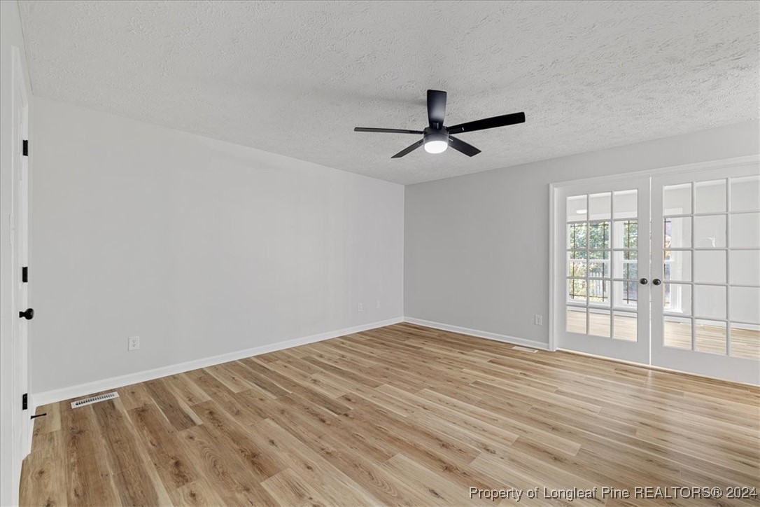 7847 Amesbury Road Fayetteville, NC 28311 - Photo 19 of 42 a view of an empty room with wooden floor and a window