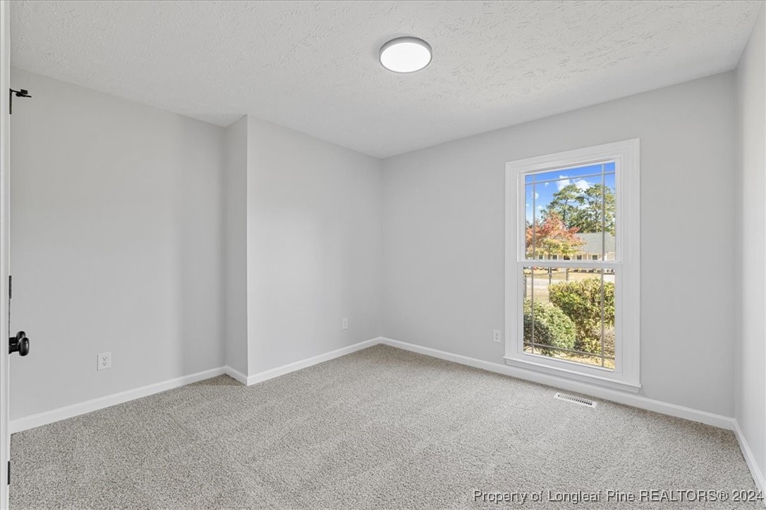 7847 Amesbury Road Fayetteville, NC 28311 - Photo 27 of 42 an empty room with windows