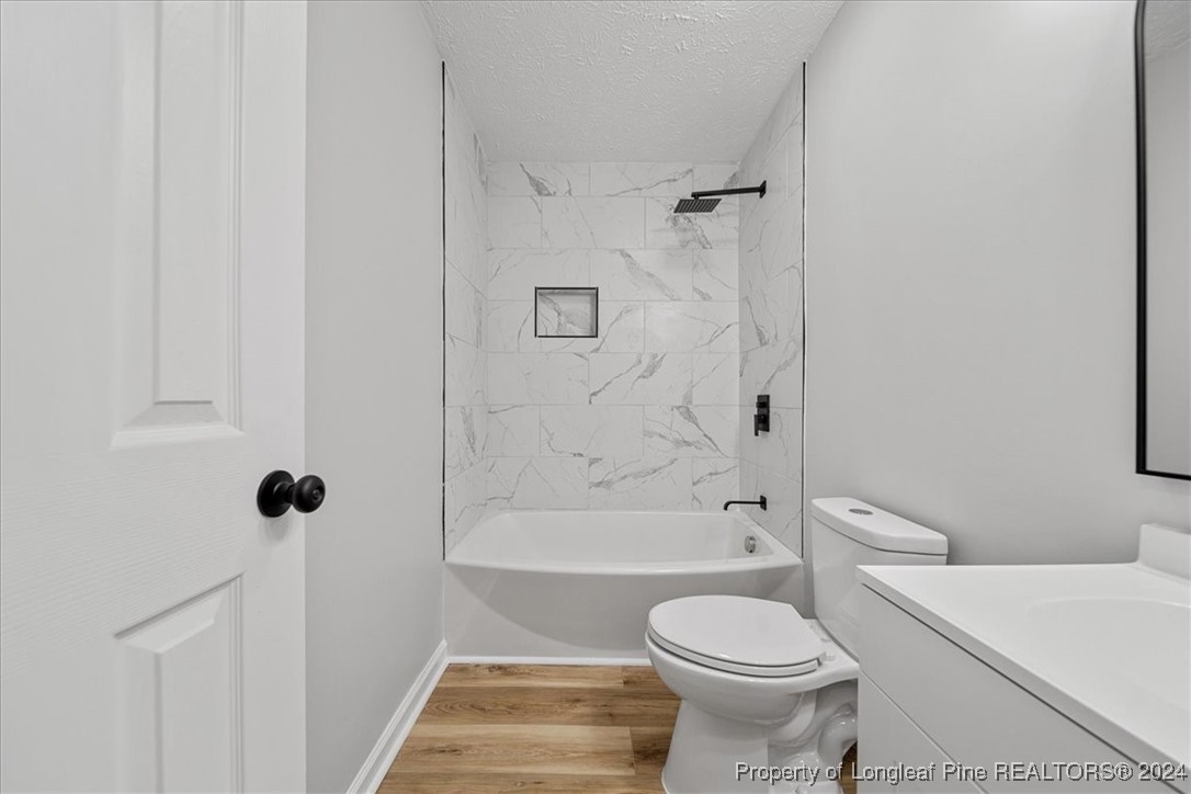 7847 Amesbury Road Fayetteville, NC 28311 - Photo 29 of 42 a bathroom with a toilet sink and shower