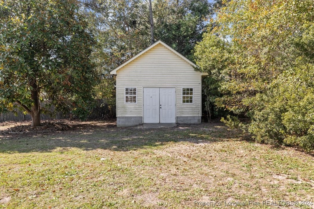 7847 Amesbury Road Fayetteville, NC 28311 - Photo 36 of 42 a view of a backyard with large trees