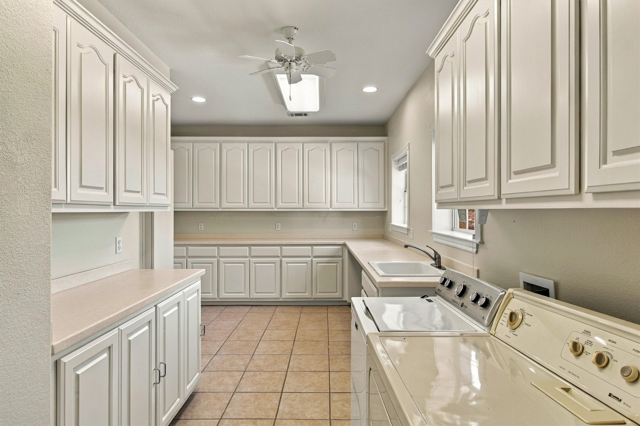 1651 Old Red Ranch Road Dripping Springs, TX 78620 - Photo 17 of 31 Abundant cabinetry and tile flooring define this highly functional multi-use workspace.