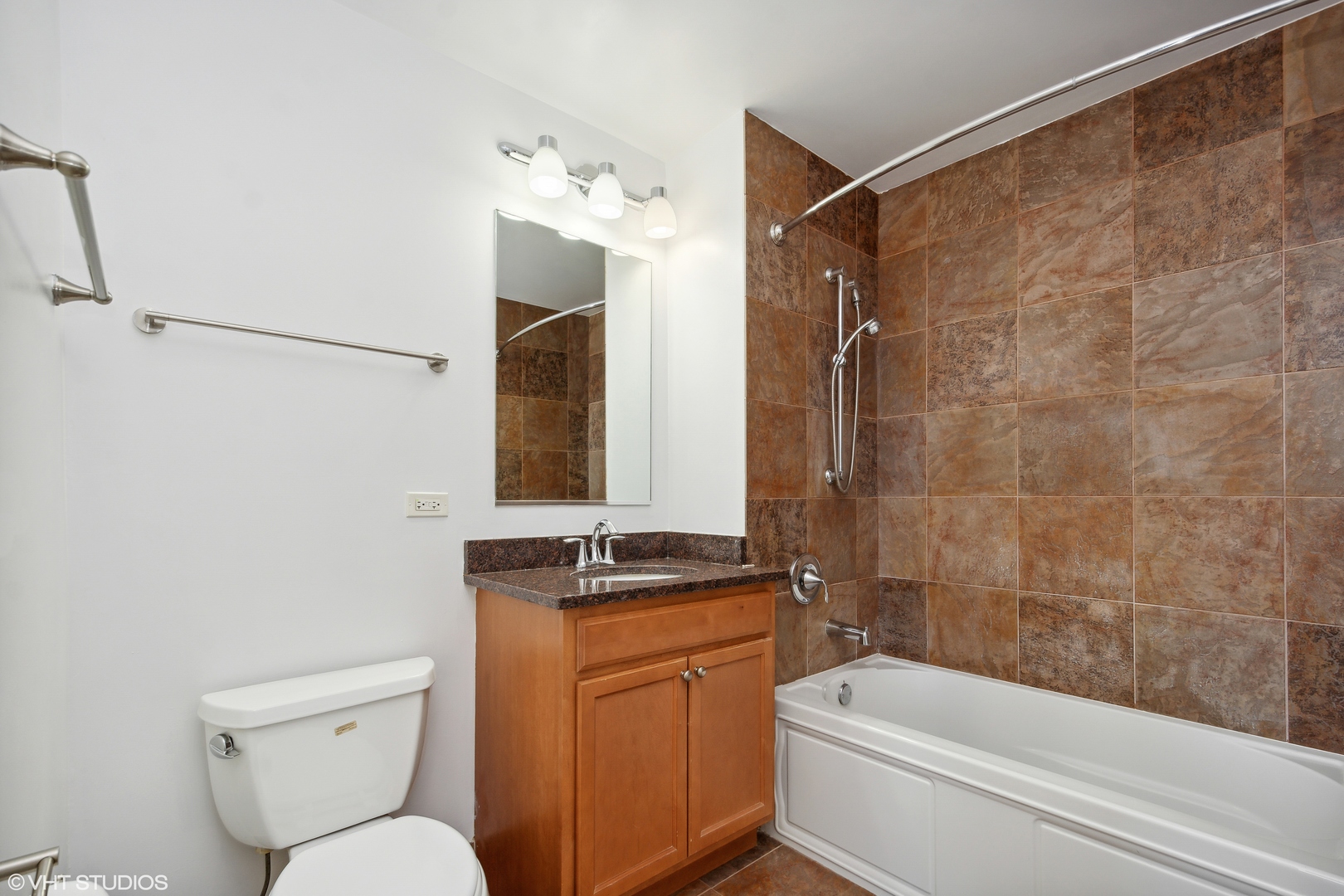 1791 West Howard Street, Unit 504 Chicago, IL 60626 - Photo 13 of 23 a bathroom with a granite countertop sink toilet and shower